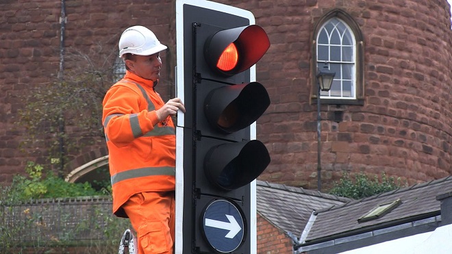 Photo of our technicians performing maintenance on a traffic light