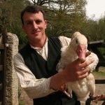 An image of Victorian Farm star Alex Langlands in period farming clothes holding a goose. Alex will be returning to Acton Scott Historic Working Farm on Saturday 25 May 2019.