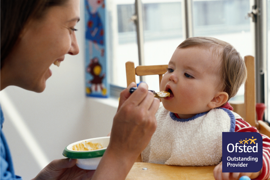 Image of mother feeding baby at home