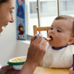Image of mother feeding baby at home