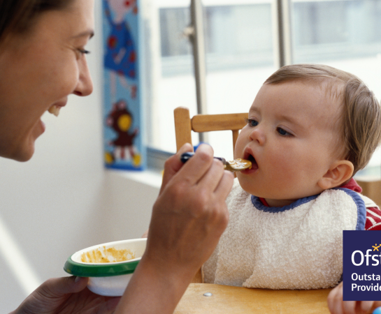 Image of mother feeding baby at home