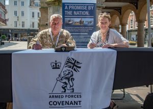 A man and a woman signing a document