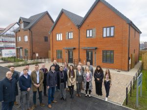 Cornovii Developments staff and Councillor Dean Carroll standing in front of one of the newly constructed houses