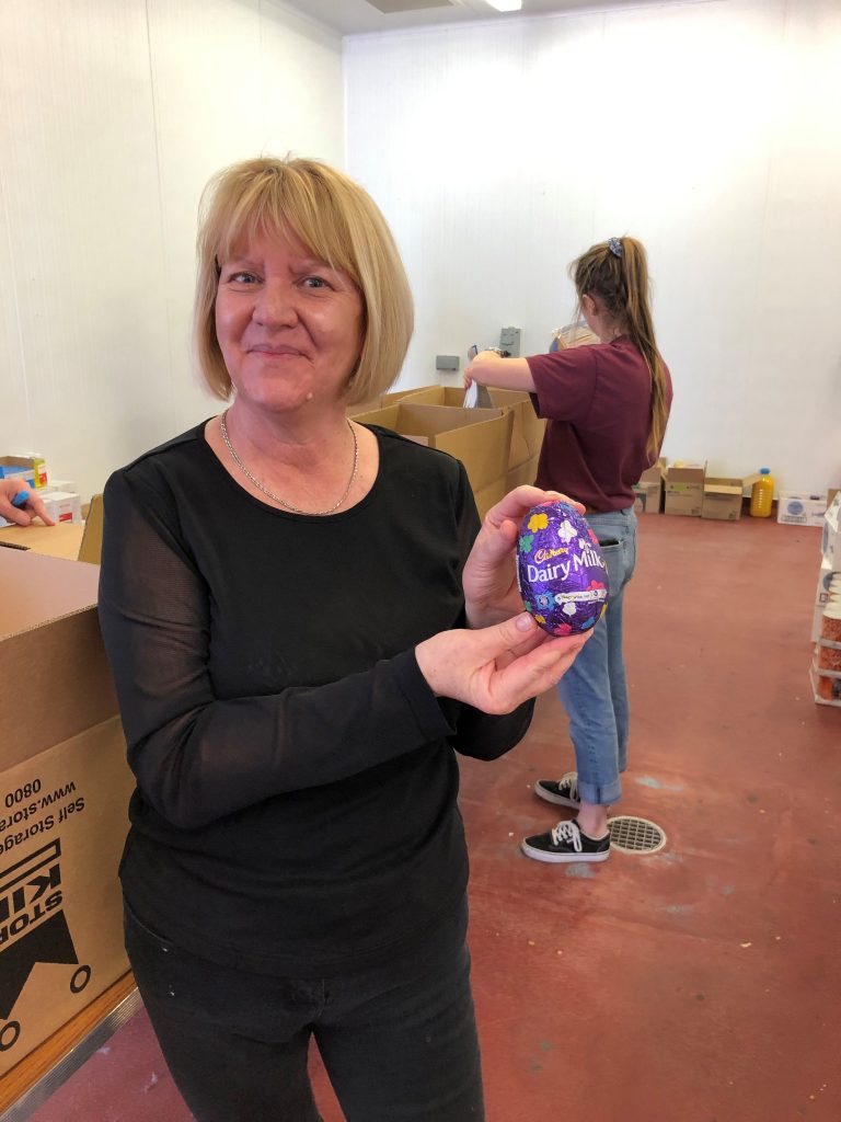 An image of a Shropshire Council member of staff with one of 1,250 chocolate eggs that will be delivered to households affected by coronavirus.