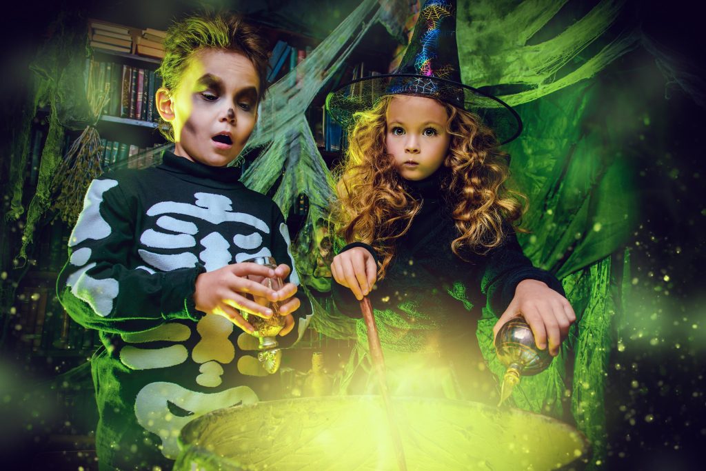 An image of two children dressed as a skeleton and a witch making a potion over a cauldron. Join Shrewsbury Museum and Art Gallery for Museums are Magic and create your own potion.