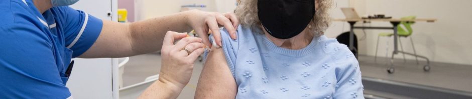 Elderly woman receiving a Covid-19 vaccine