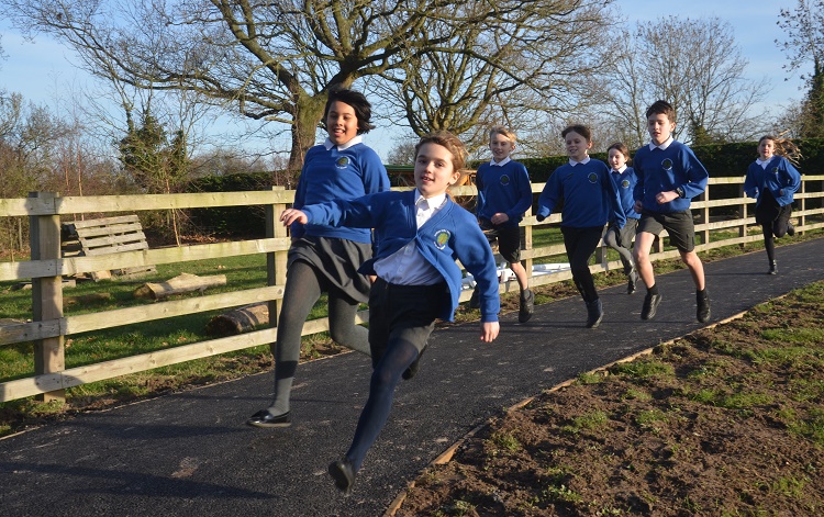 Criftins pupils go for a run on the school's new running track