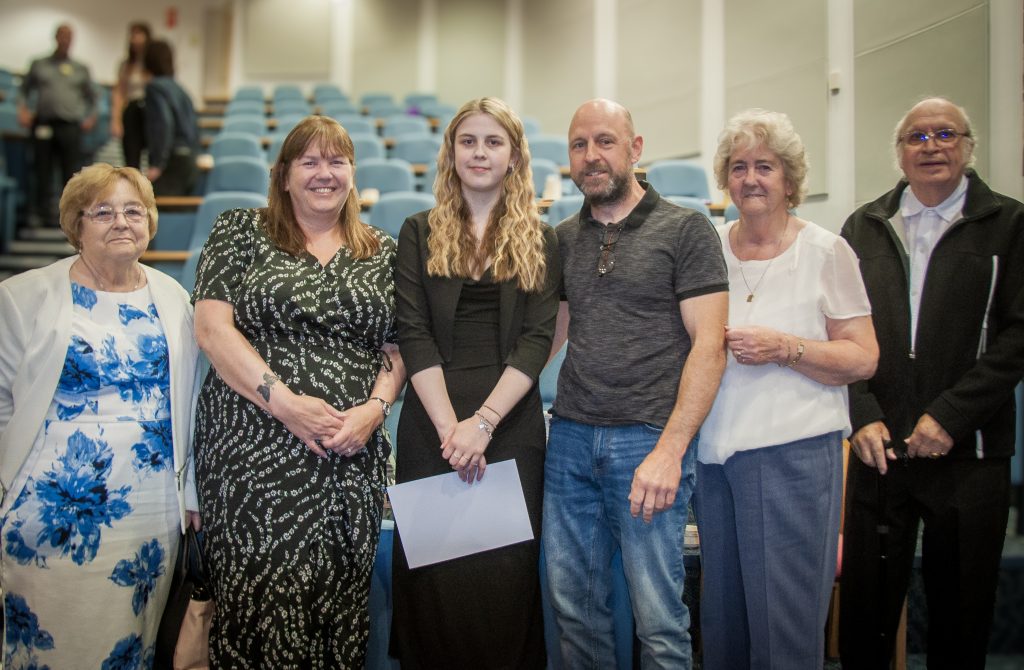 Intern with their family celebrating their graduation