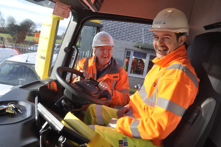 Councillor Dean Carroll sitting in the driver's seat on a gritter