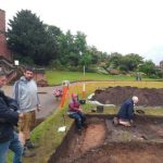 An image of volunteers on the Shrewsbury Castle excavation in and around the trench on a wet Saturday.