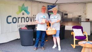 A man and a woman standing in front of seats inside the Cornovii Homes stand