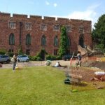 An image of the dig taking place at Shrewsbury Castle on a sunny day with Shrewsbury Castle standing proudly in the background.