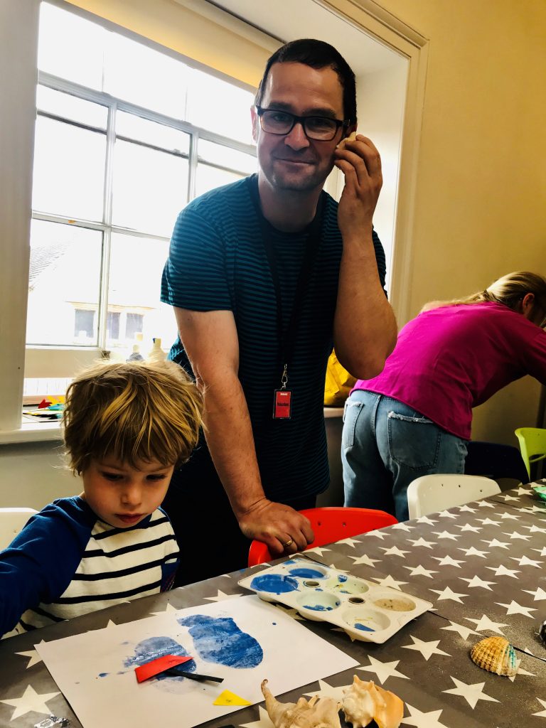 An image of a volunteer at Shrewsbury Museum and Art Gallery volunteering during the mini mammoths session.