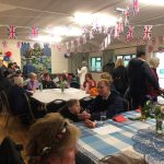 People in Longnor Village Hall, talking