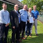 Men holding a certificate