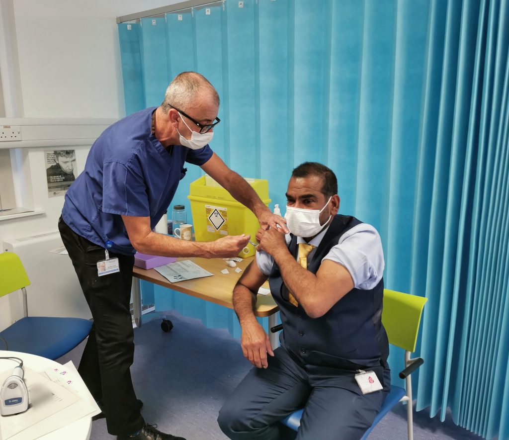 Brendan O'Grady, nurse and COVID-19 vaccinator; pictured with Sudheer Karlakki, Consultant Orthopaedic Surgeon at RJAH.