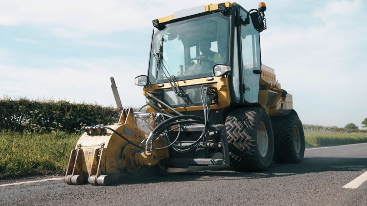 A Multevo Multihog carrying out pothole repairs on a country road