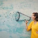 An image of a lady pretending to shout through a sketched megaphone.