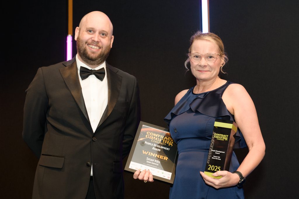 Woman holding two awards