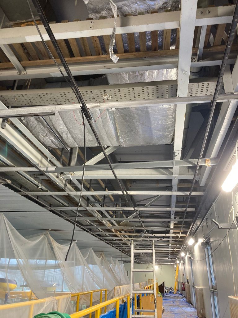ceilings being worked on at a swimming pool