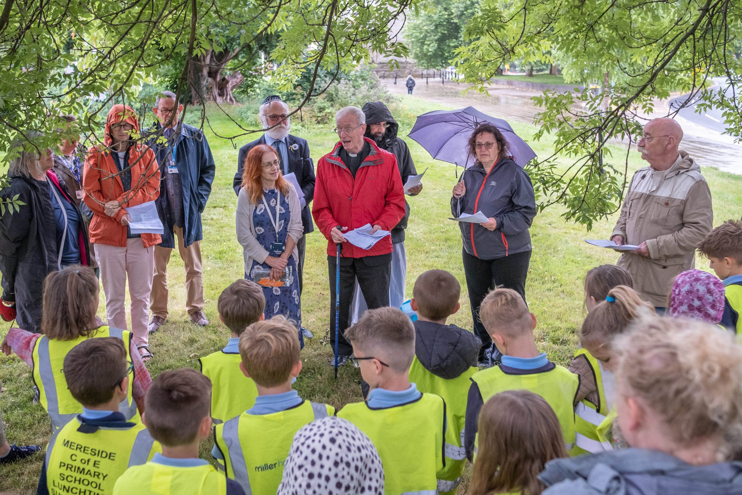 Rev Ken Chippindale from the Shrewsbury Interfaith Forum talking to pupils from Mereside Primary School by the Srebrenica tree outside Shirehall in Shrewsbury.