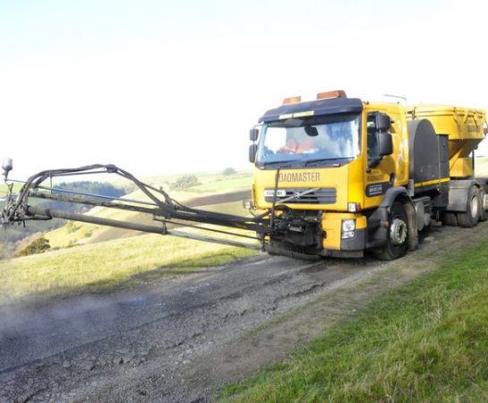 A roamaster repairing a road