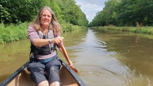 A woman paddling a canoe on the Shropshire Union canal