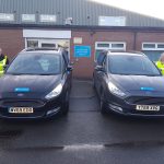 An image of two of Shropshire Council's vehicle fleet and socially distanced members of staff who have been helping Shropshire's vulnerable residents get their COVID-19 vaccines