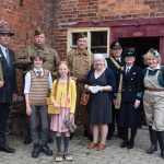 An image of people dressed in 1940's period clothing at Acton Scott Historic Working Farm for the Wartime Farm event.