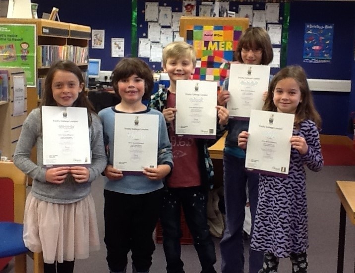 Children receiving their certificates in their local library after completing the Arts Award in a previous year.