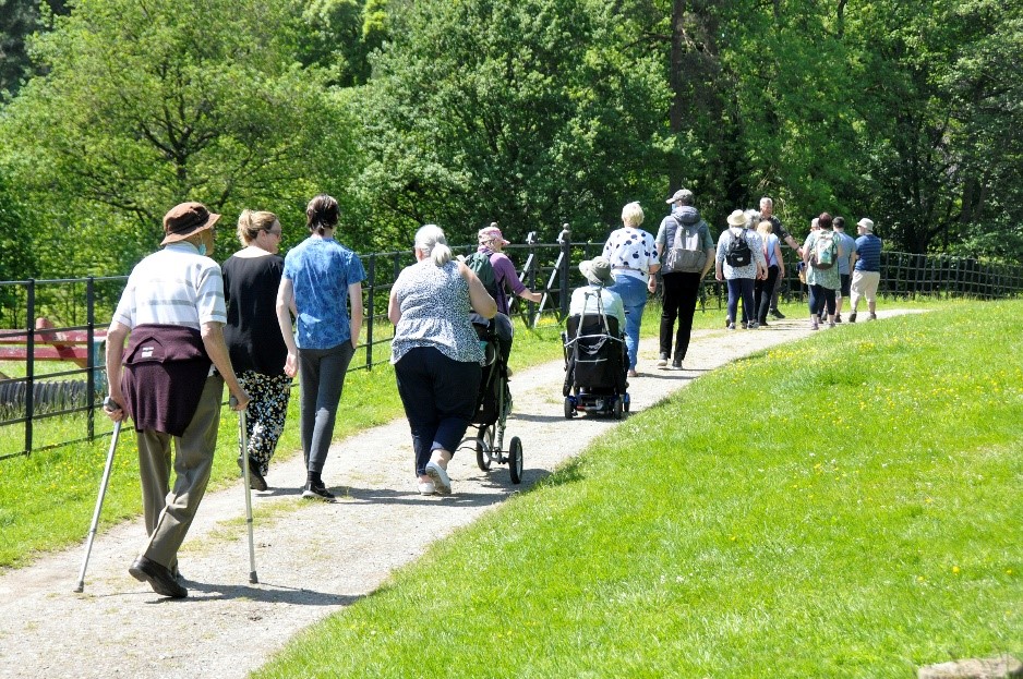 Many people walking in a park, for Carers Week 2021