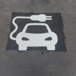 Electric vehicle charger space sign painted on road