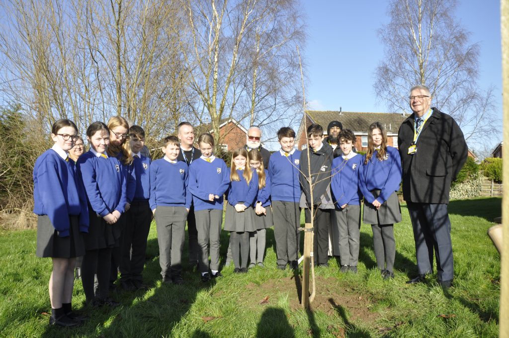 Schoolpupils of Ellesmere Primary School planting their cherry tree