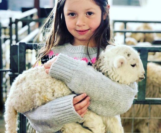 A girl with a sheep.