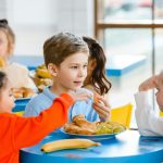 Three children sharing a free school meal