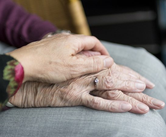 Three hands on a cushion