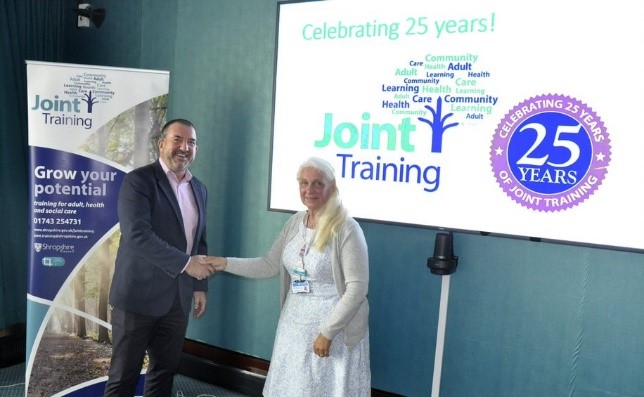 Andy Begley, Shropshire Council's chief executive, also congratulating Christine Scott, Joint Training Manager, on 40 years of service with the council. (COVID-19-compliant venue and practices in place)