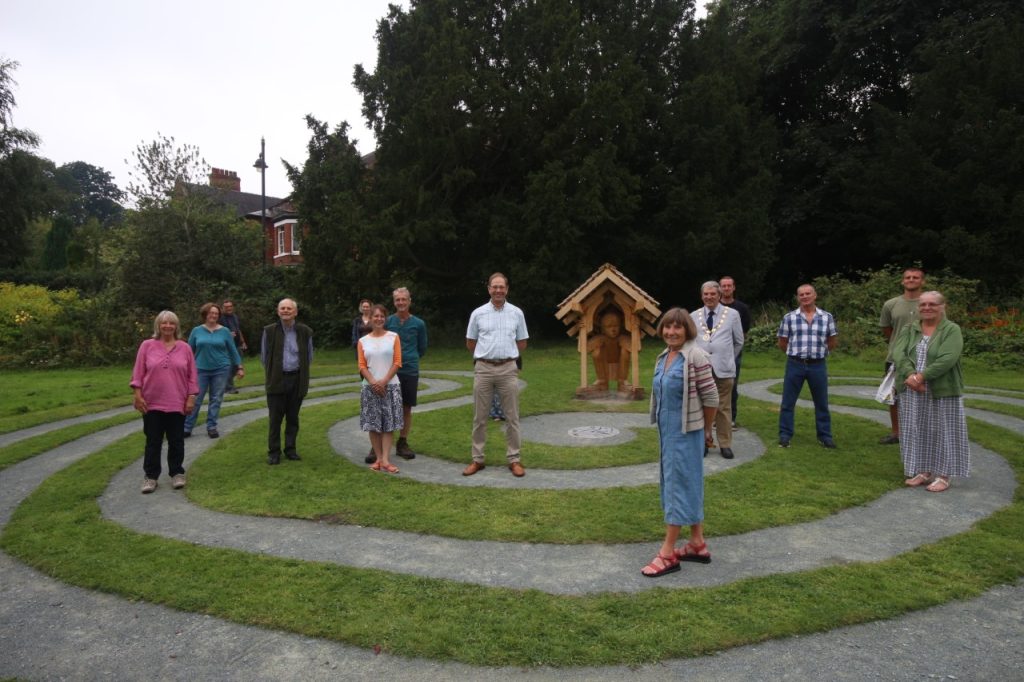 Keeping their distance: guests, artists and volunteers mark the completion of the new labyrinth.