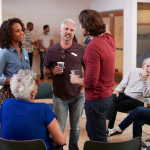 People talking with drinks in their hand