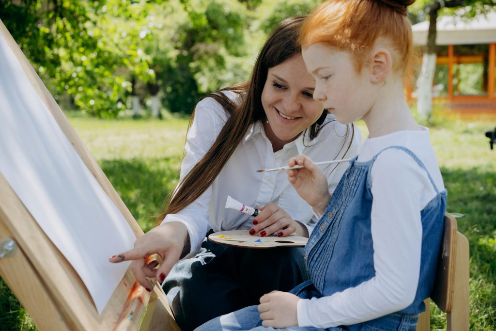 Library image of woman and young girl painting: Credit Mikhail Nilov, Pexels images 