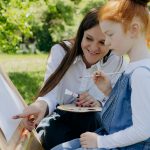 Library image of woman and young girl painting: Credit Mikhail Nilov, Pexels images