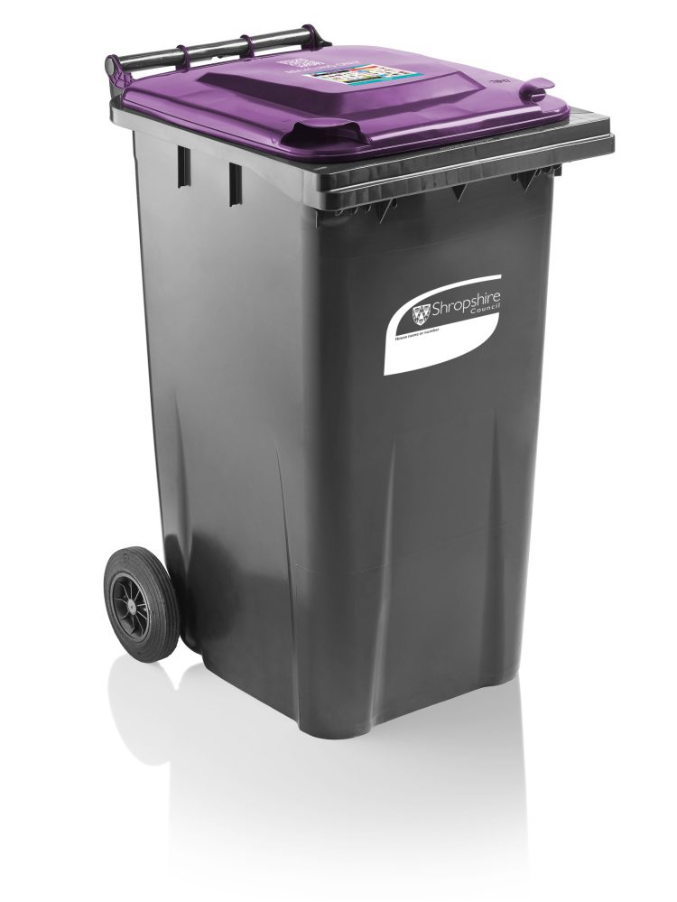 A black wheelie bin with a purple lid
