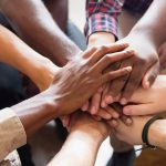 8 people joining hands