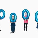 RJAH: 100,000th vaccination - people holding balloons
