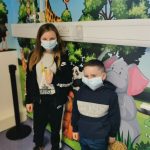 Pictured are Emmy Jones, aged 11, and her younger brother, Jack, 6, from Ellesmere, stood in front of the jungle-themed mural at the RJAH Vaccination Centre.