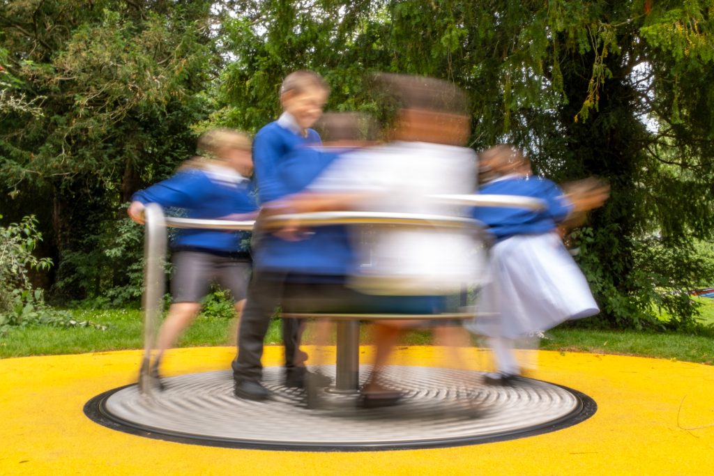 Children on the new roundabout at Cremorne Gardens play park.