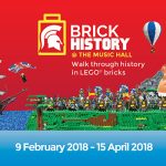 An image of a banner promoting Lego: Brick History which is at Shrewsbury Museum and Art Gallery from 9 February until 15 April 2018. The banner shows lego creations of ships, a volcano and representations of historic battles.