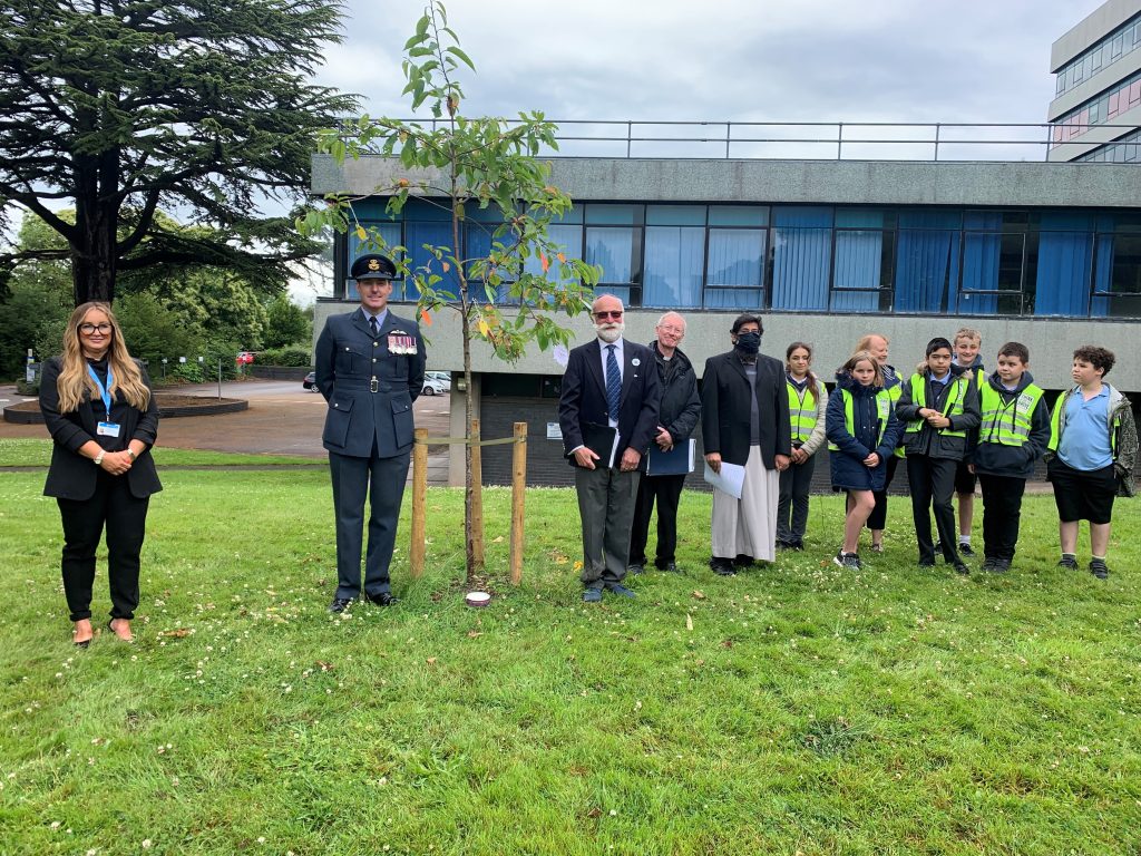(l to r) Lois Dale (Shropshire Council's rurality equality specialist), Wing Commander Turner, Mark Michaels, Reverend Ken Chippindale, Imam Sohayb Peerbhai; and children of Mereside School.