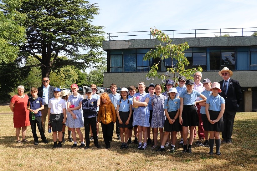 Ceremony guests and Mereside Primary School pupils gather at the memorial tree on Srebrenica Memorial Day
