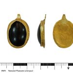 A mostly complete gold pendant with large garnet setting dating to the Early Medieval period. Credit: National Museums Liverpool